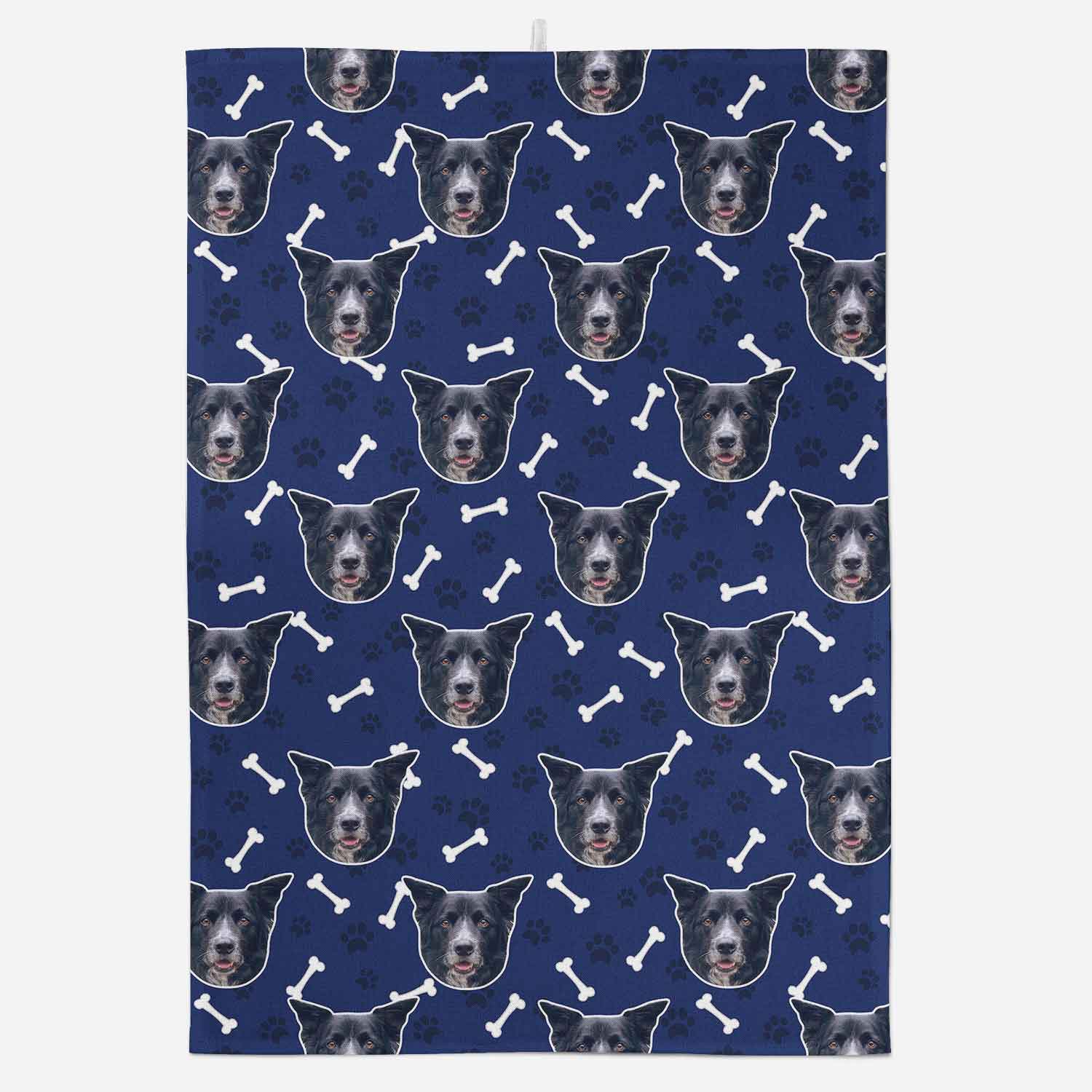 Patterned towel with dog faces and bones on a blue background