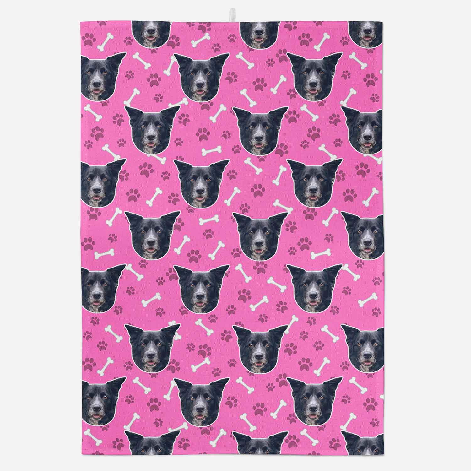 Pink towel with black dog faces and bone/paw pattern