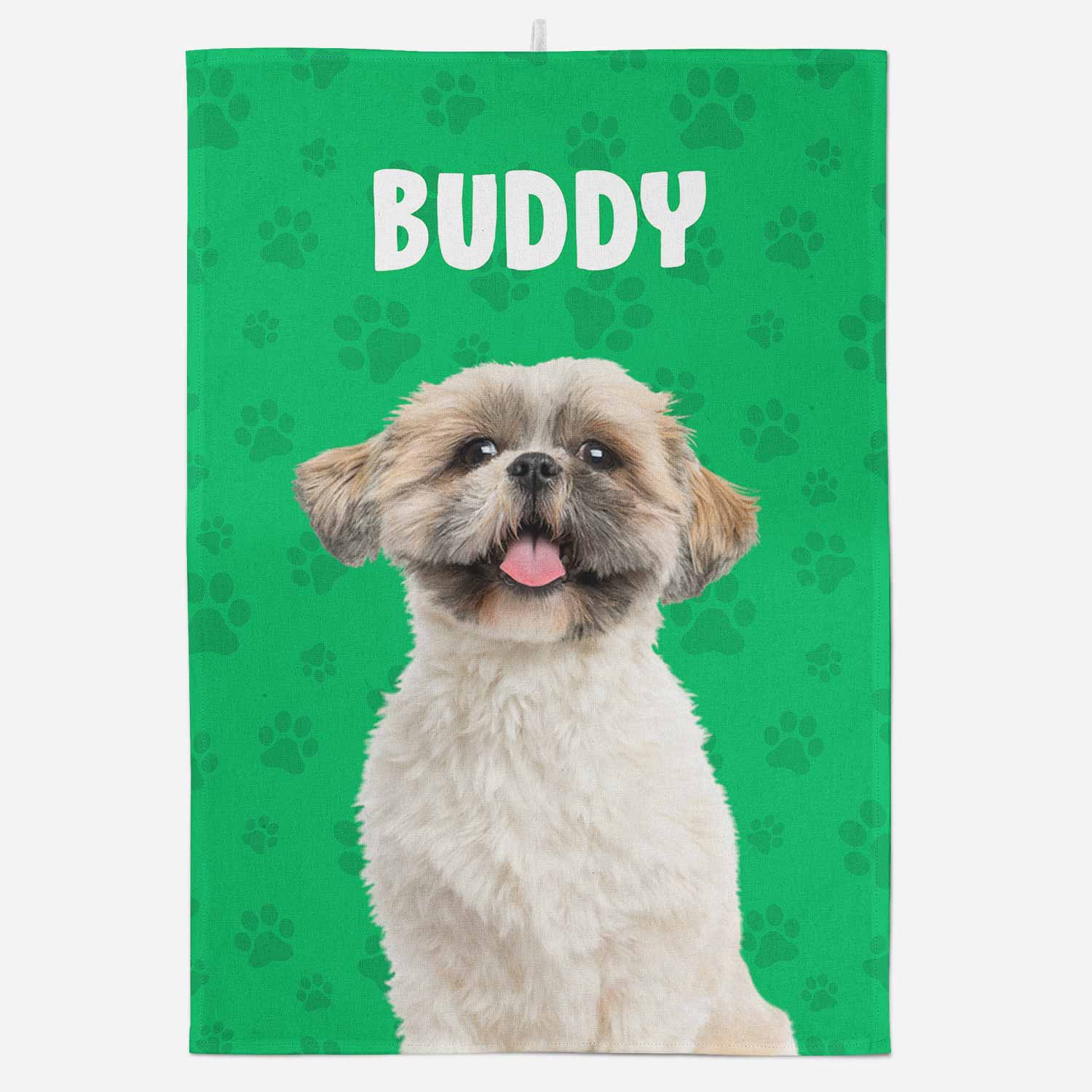 Dog towel with a dog's face on a green background with paw prints and the name 'Buddy'.