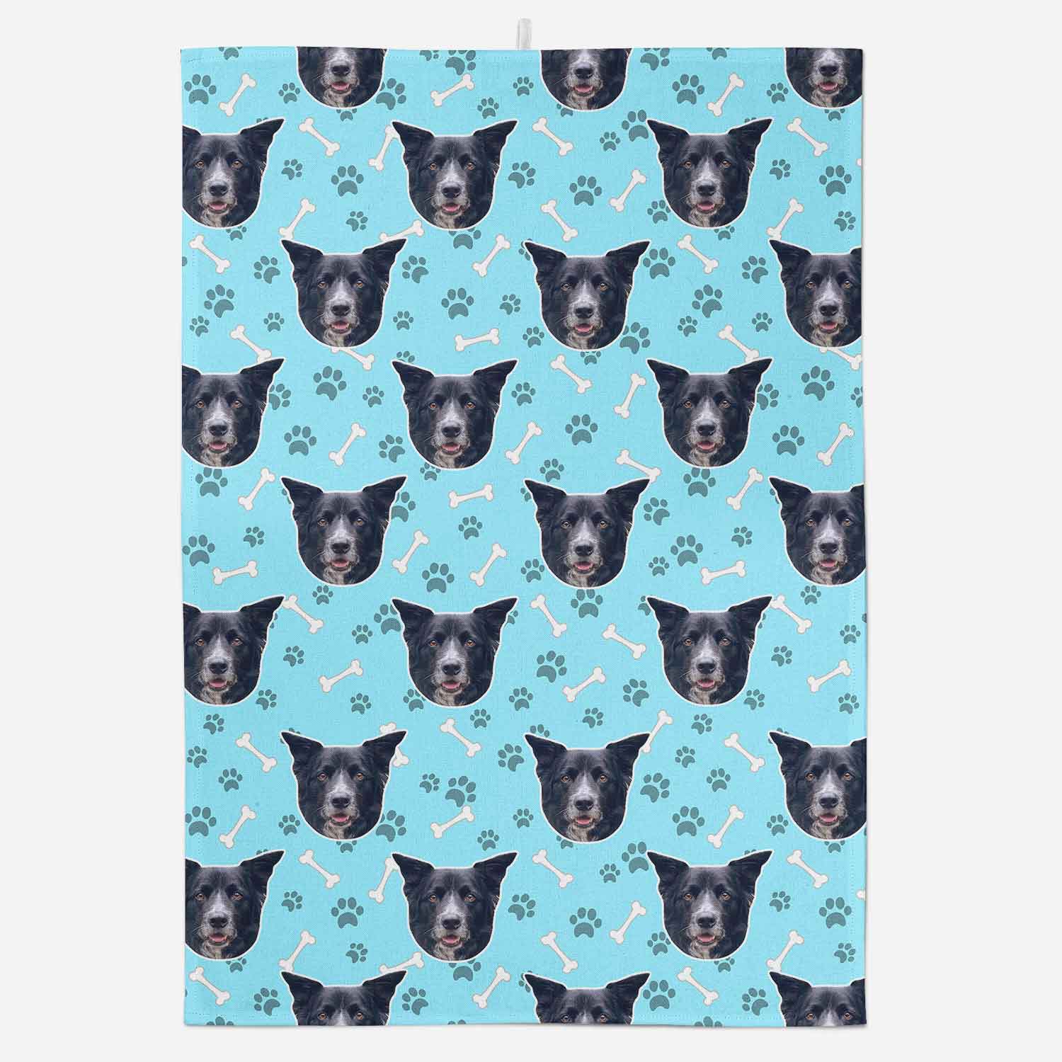 Patterned fabric with dog faces and bones on a blue background