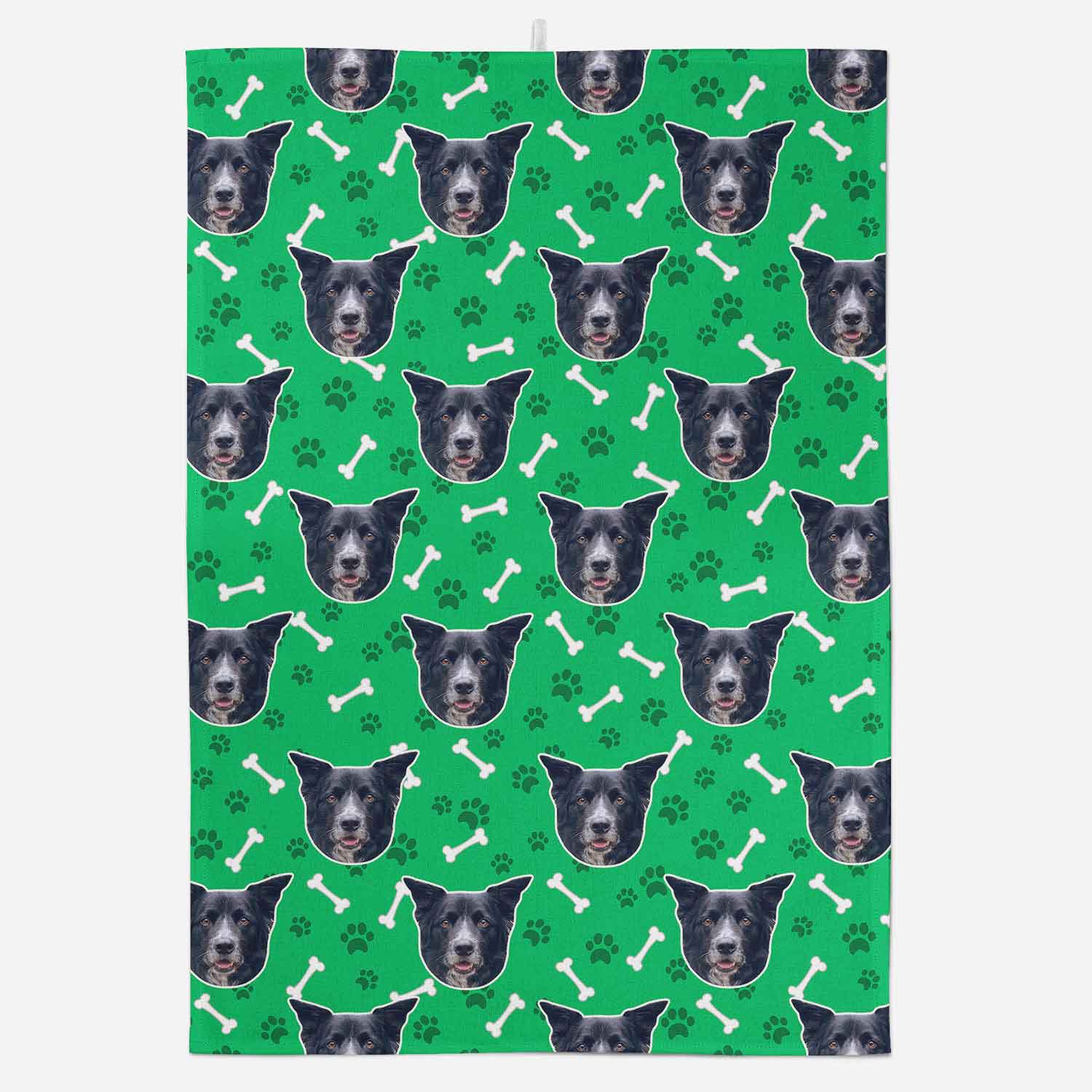 Patterned towel with dog faces and bones on a green background