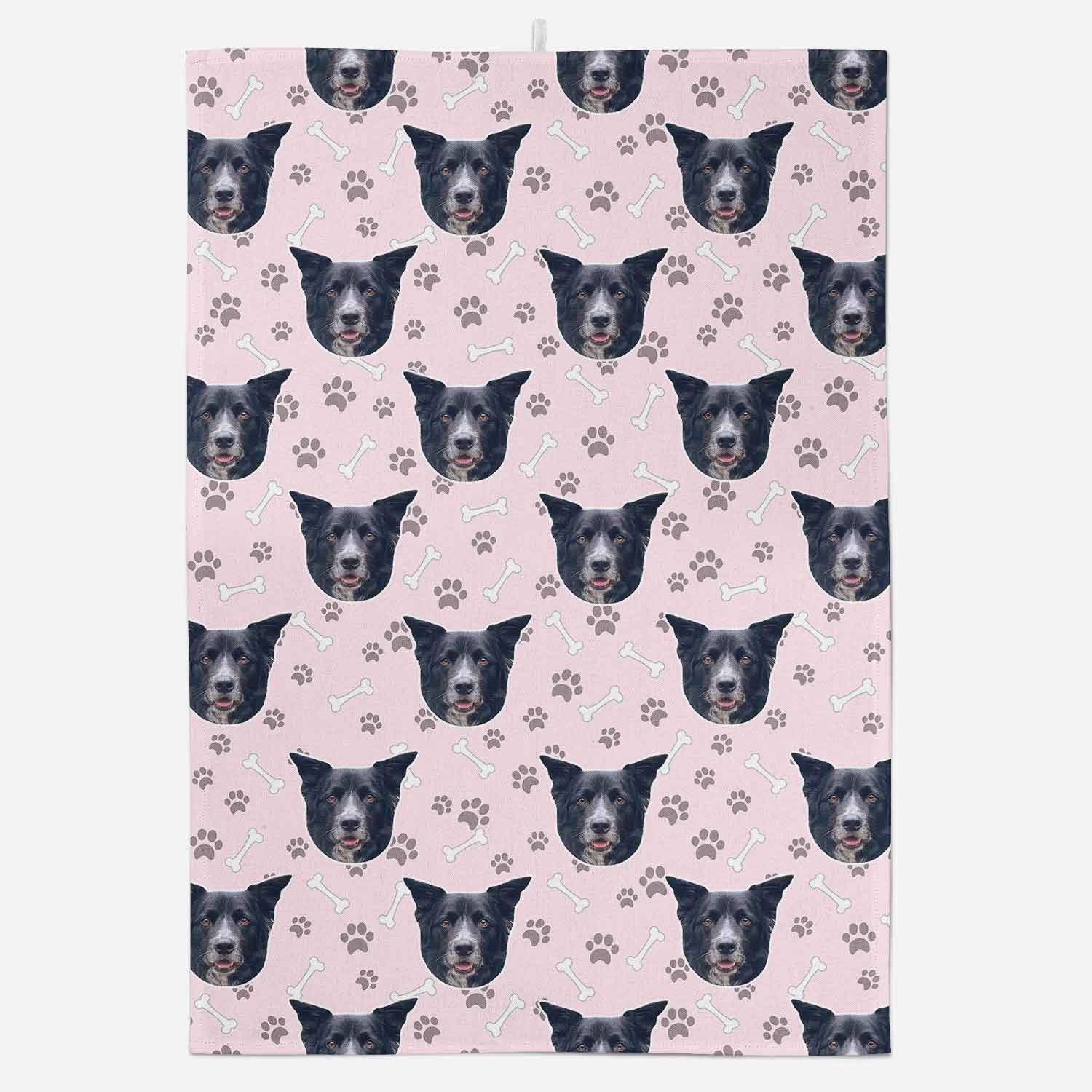 Patterned paper with repeated dog face design on a pink background