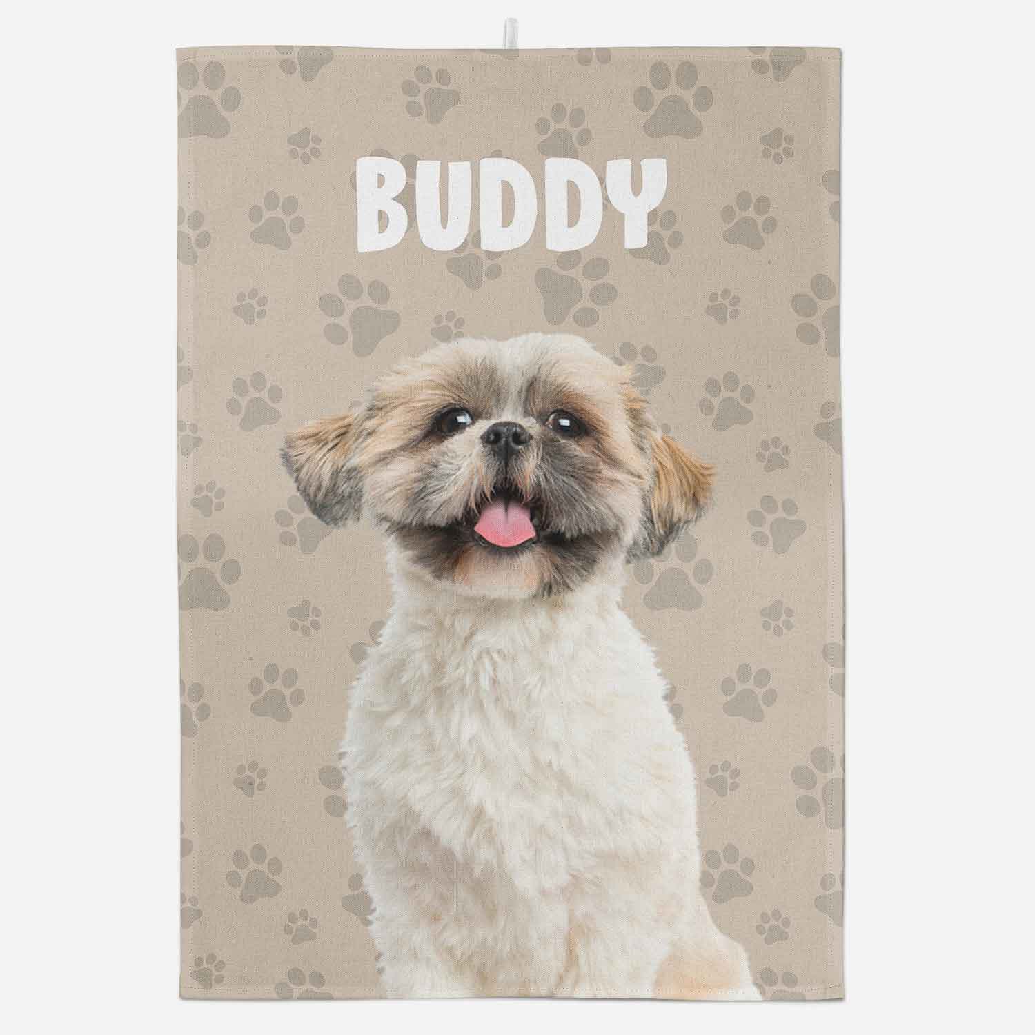 Dog with 'Buddy' text on a towel with paw print pattern